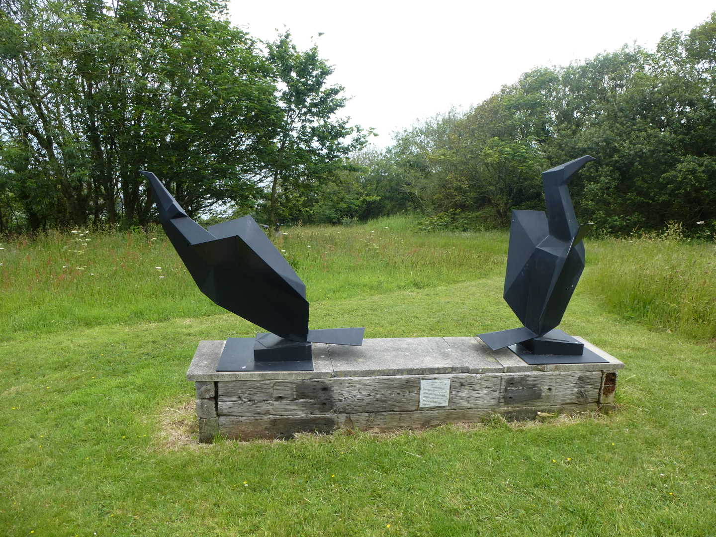 A modern sculpture consisting of two bird like figures