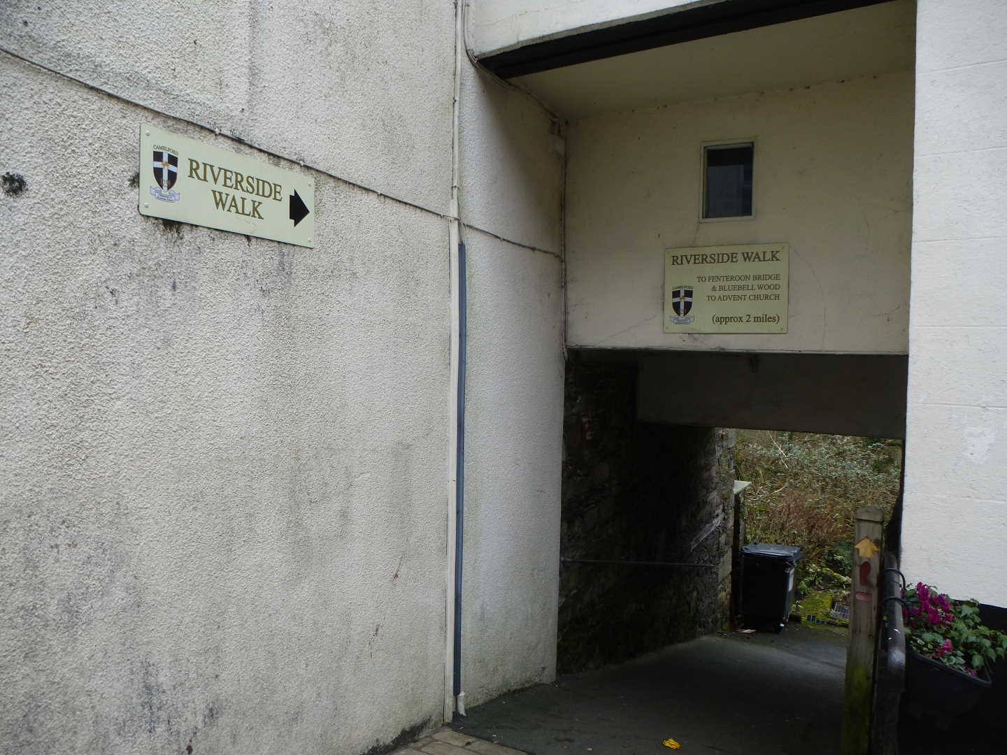 A walkway with a sign showing the directions to the walk