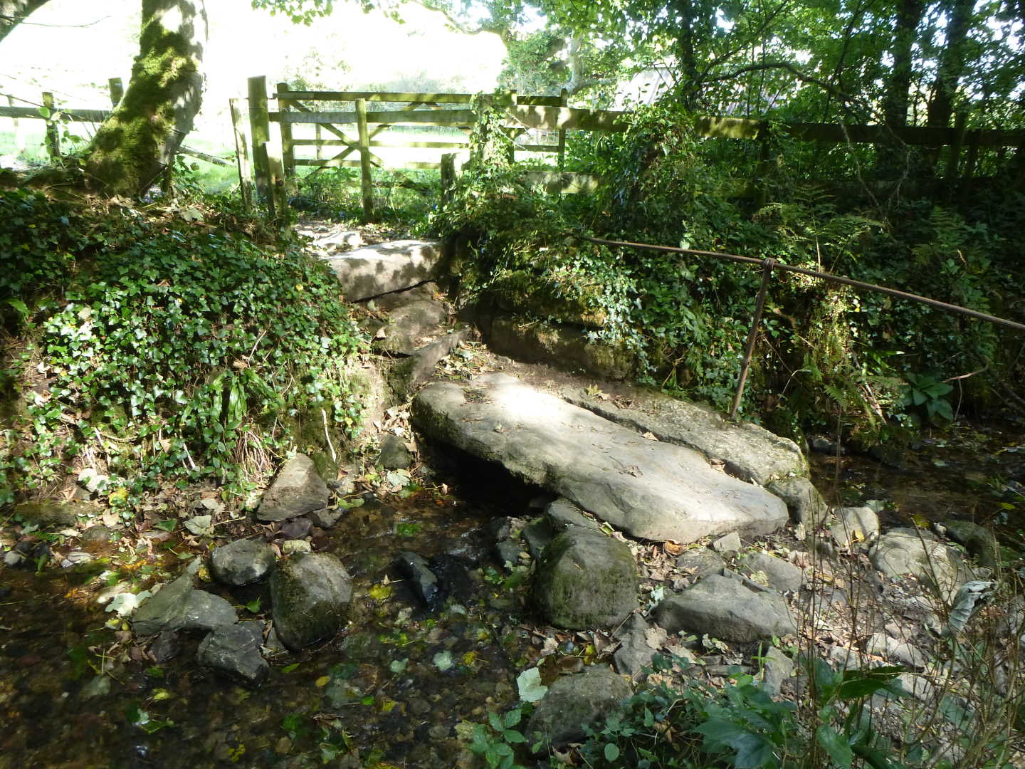 A small stone footbridge crossing a stream